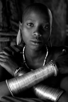 Suri-woman-inside-hut-with-bracelets-Ethiopia-23x34.4